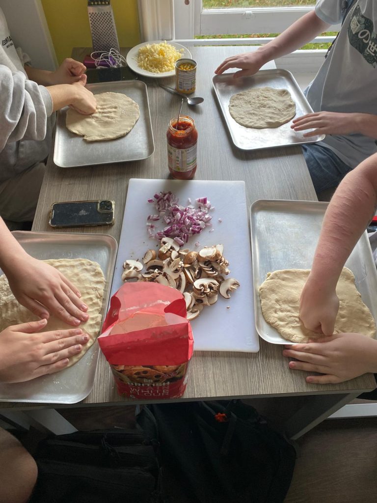 Homemade pizza activity on resident Swanage trip